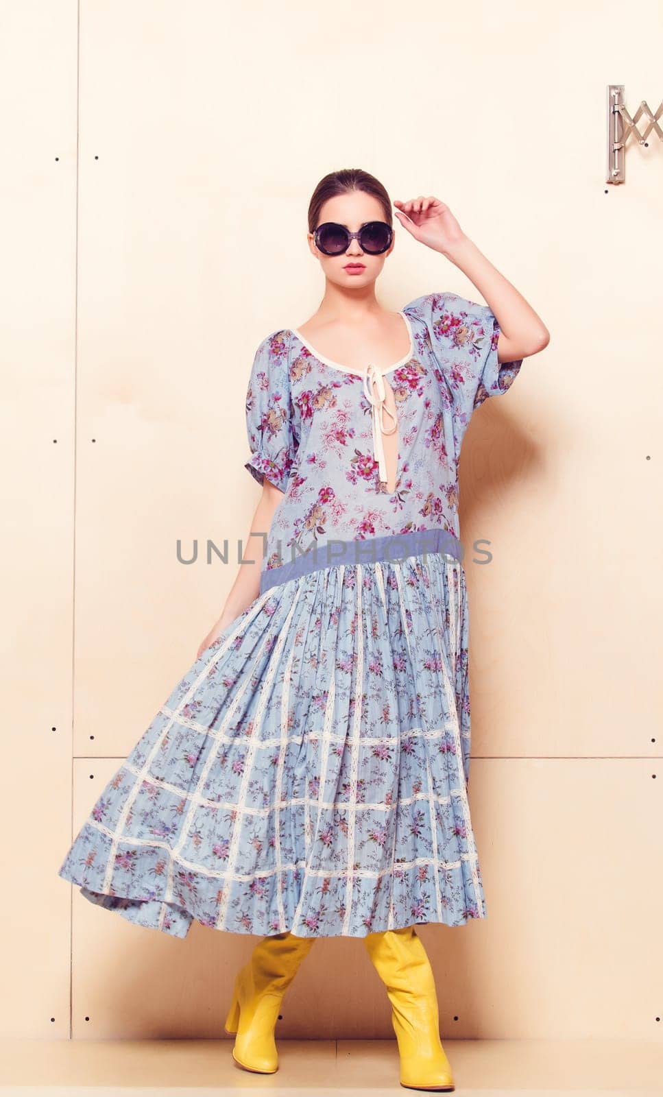 Full-length portrait of a lovely woman in romantic dress on wodden background