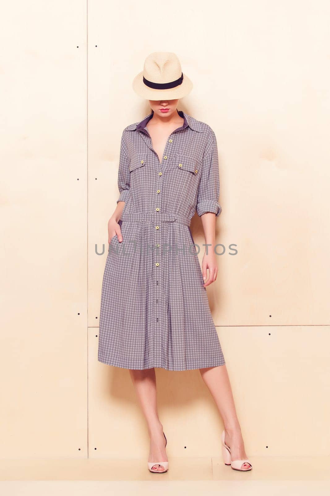 Full-length portrait of a lovely woman in romantic dress on wodden background
