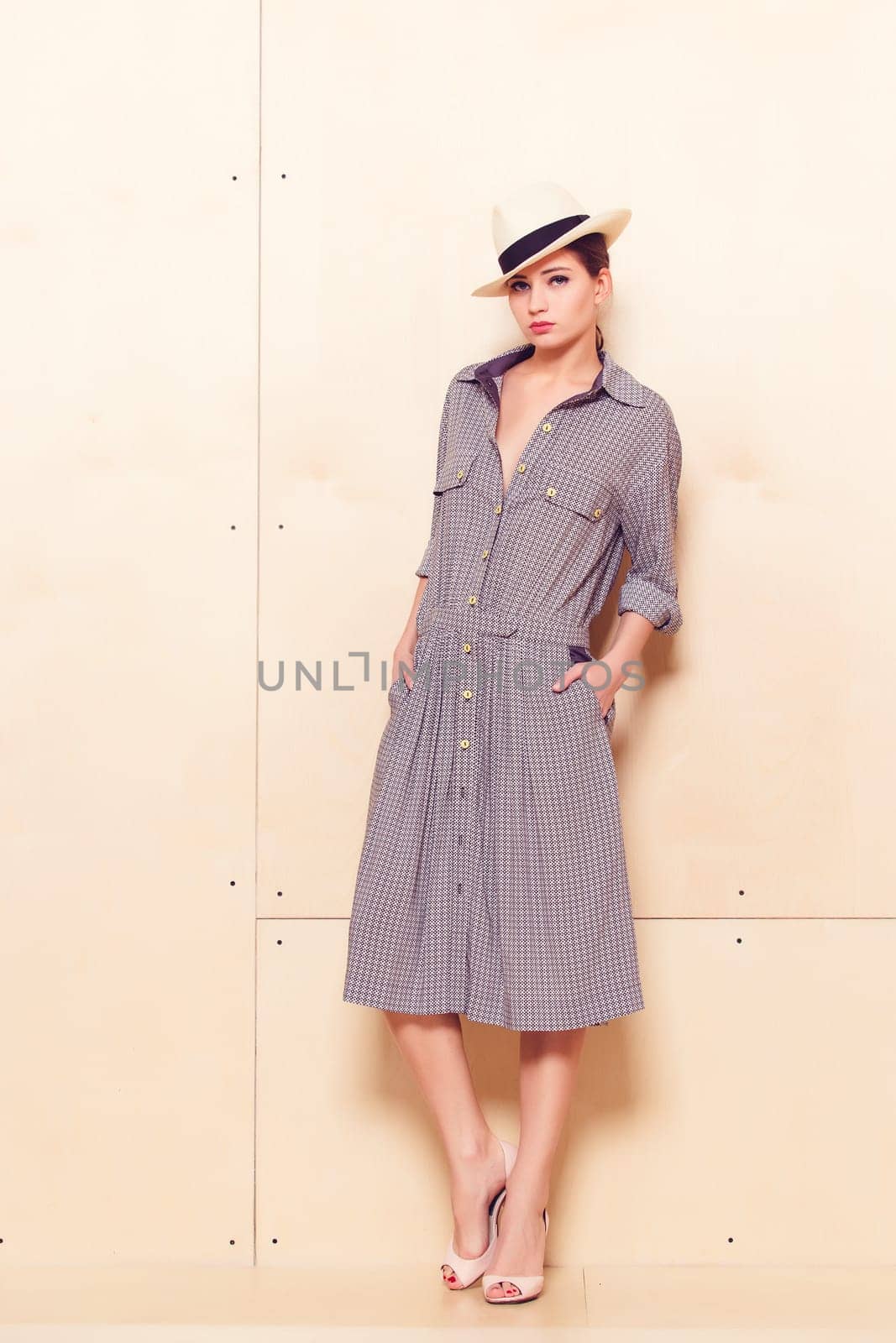 Full-length portrait of a lovely woman in romantic dress on wodden background