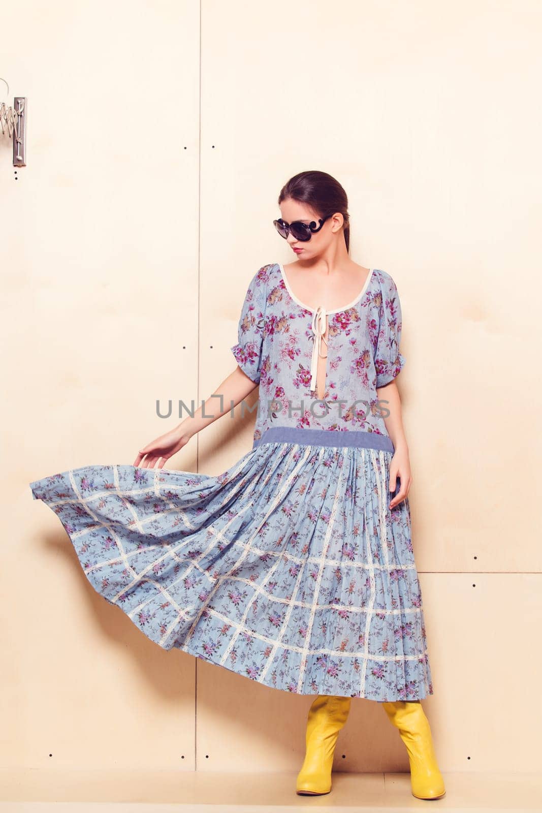 Full-length portrait of a lovely woman in romantic dress on wodden background
