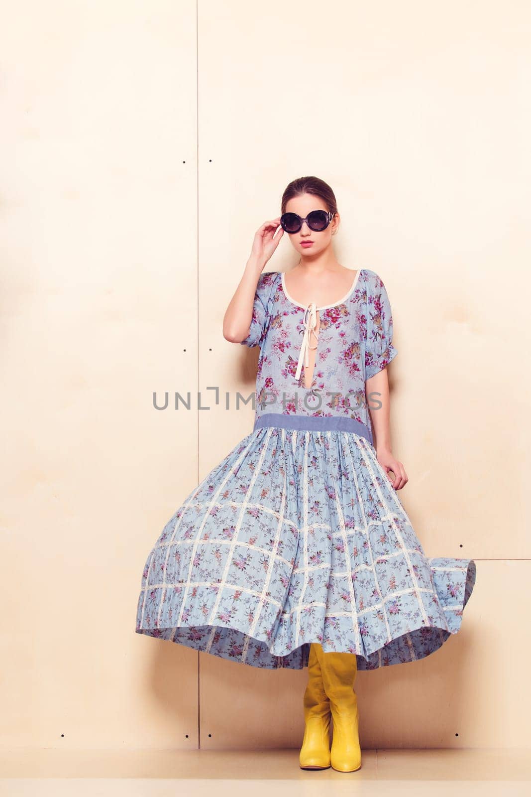Full-length portrait of a lovely woman in romantic dress on wodden background