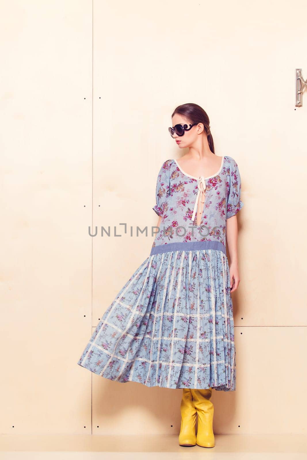 Full-length portrait of a lovely woman in romantic dress on wodden background