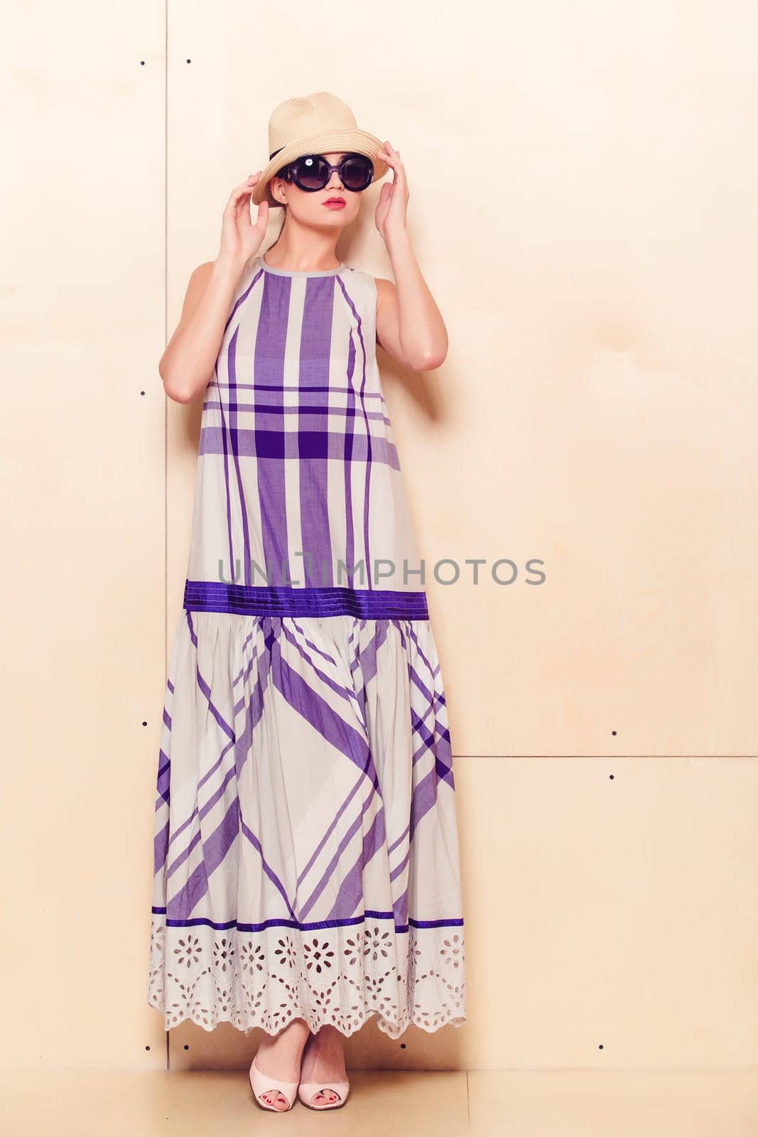 Full-length portrait of a lovely woman in romantic dress on wodden background