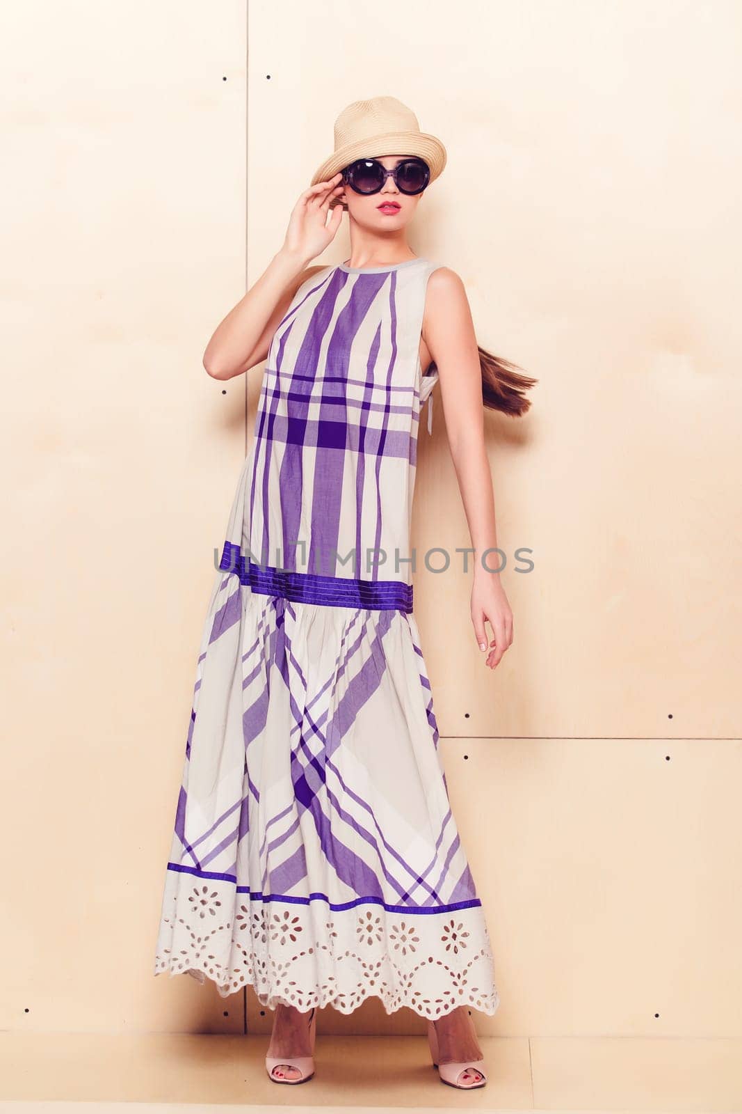 Full-length portrait of a lovely woman in romantic dress on wodden background