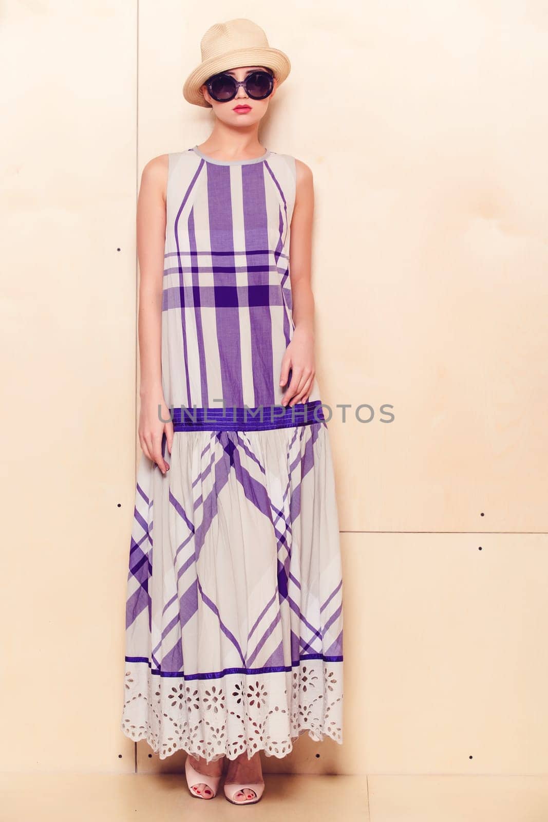 Full-length portrait of a lovely woman in romantic dress on wodden background