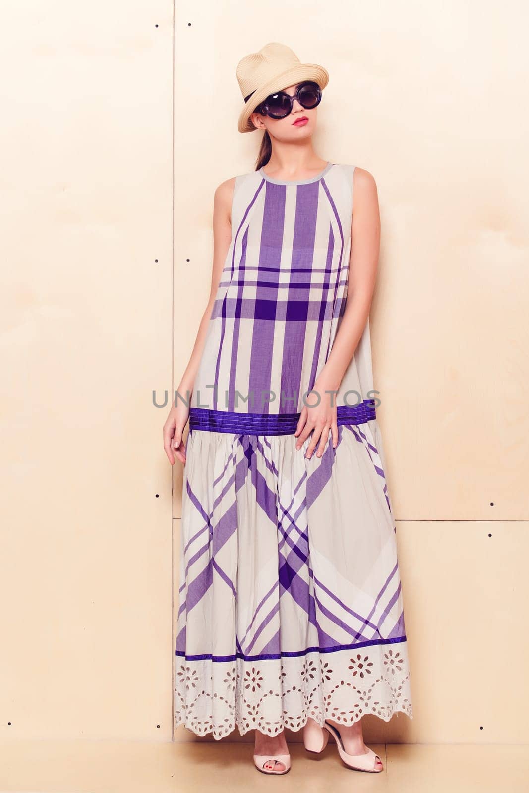 Full-length portrait of a lovely woman in romantic dress on wodden background