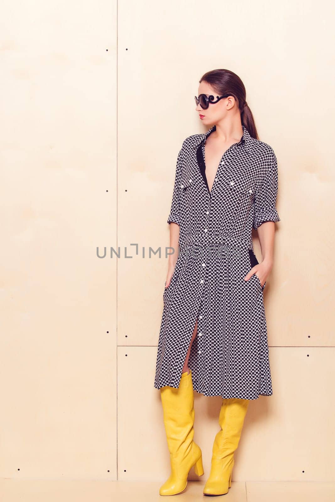 Full-length portrait of a lovely woman in romantic dress on wodden background