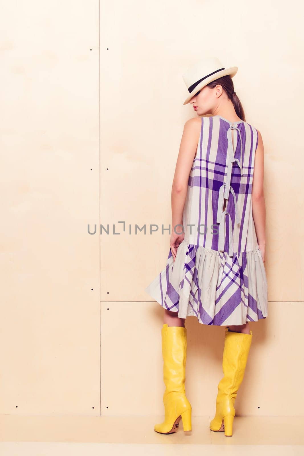 Full-length portrait of a lovely woman in romantic dress on wodden background
