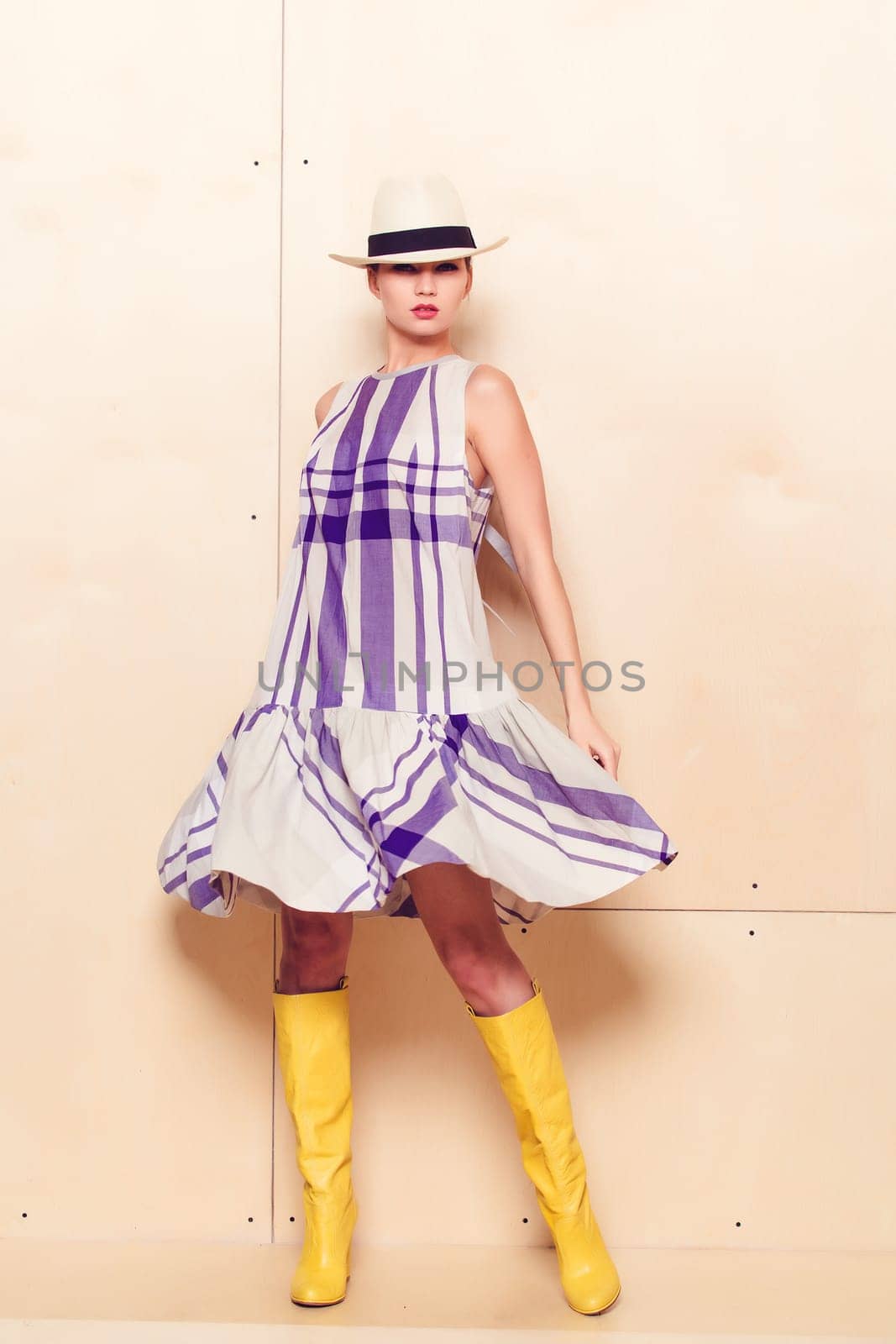 Full-length portrait of a lovely woman in romantic dress on wodden background