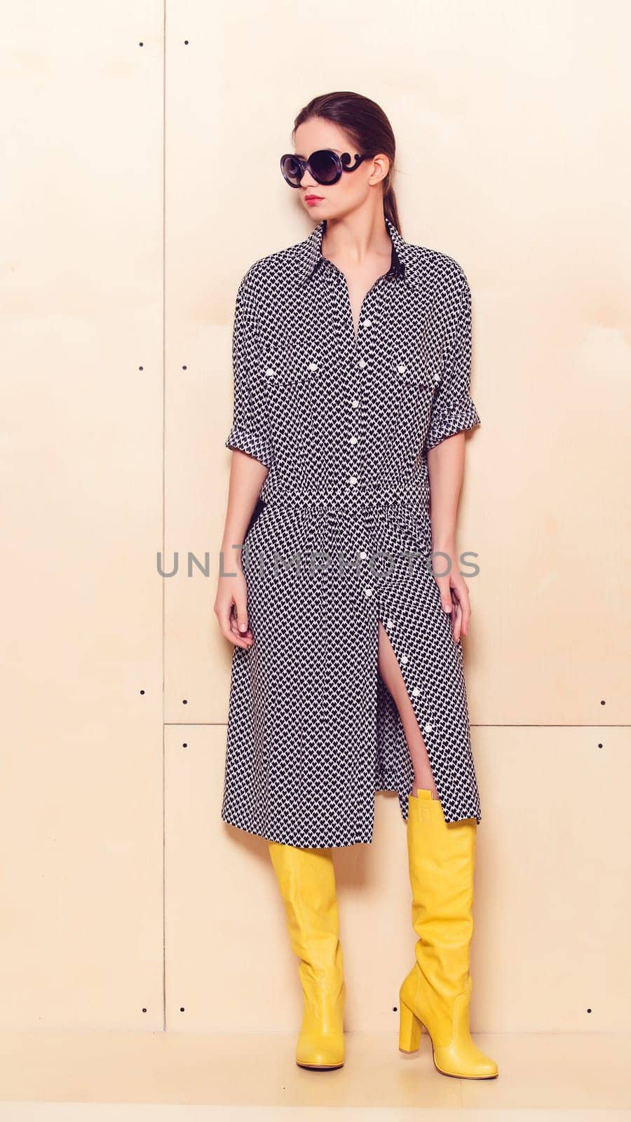 Full-length portrait of a lovely woman in romantic dress on wodden background