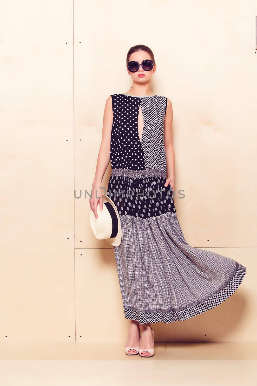 Full-length portrait of a lovely woman in romantic dress on wodden background