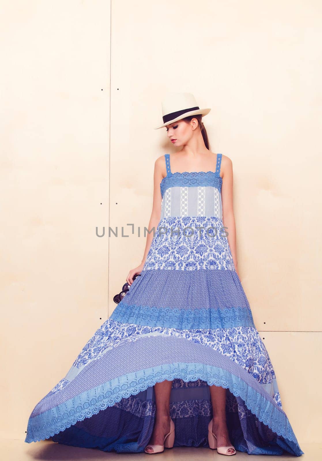 Full-length portrait of a lovely woman in romantic dress on wodden background