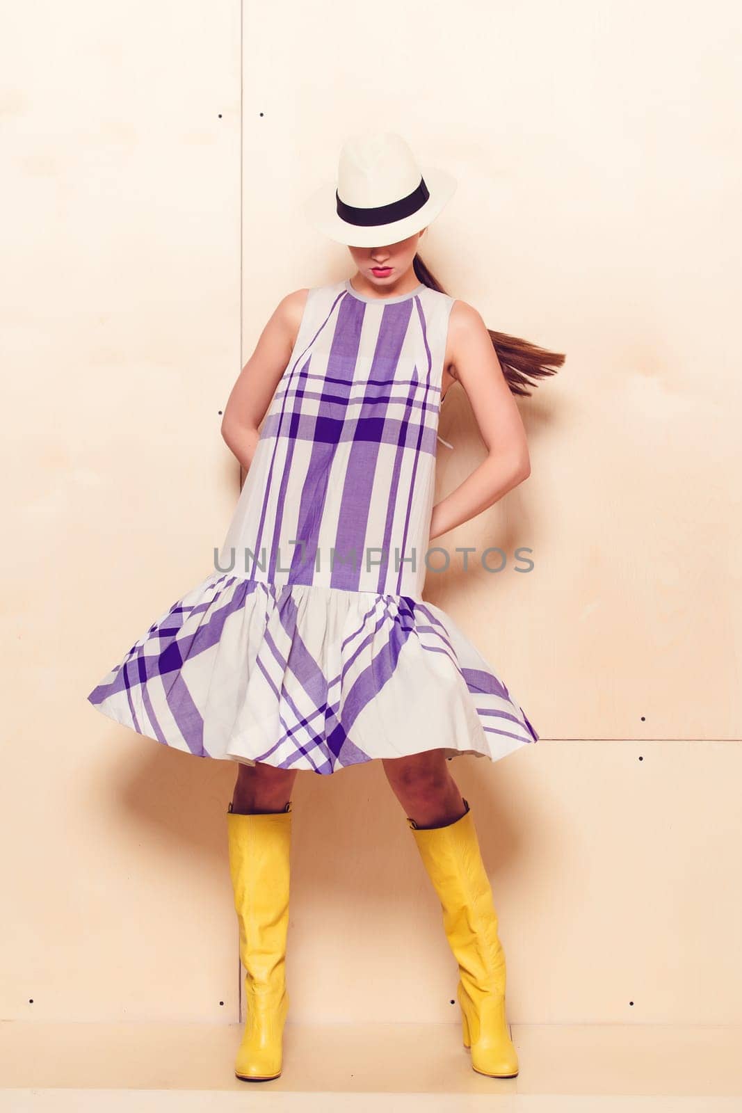 Full-length portrait of a lovely woman in romantic dress on wodden background