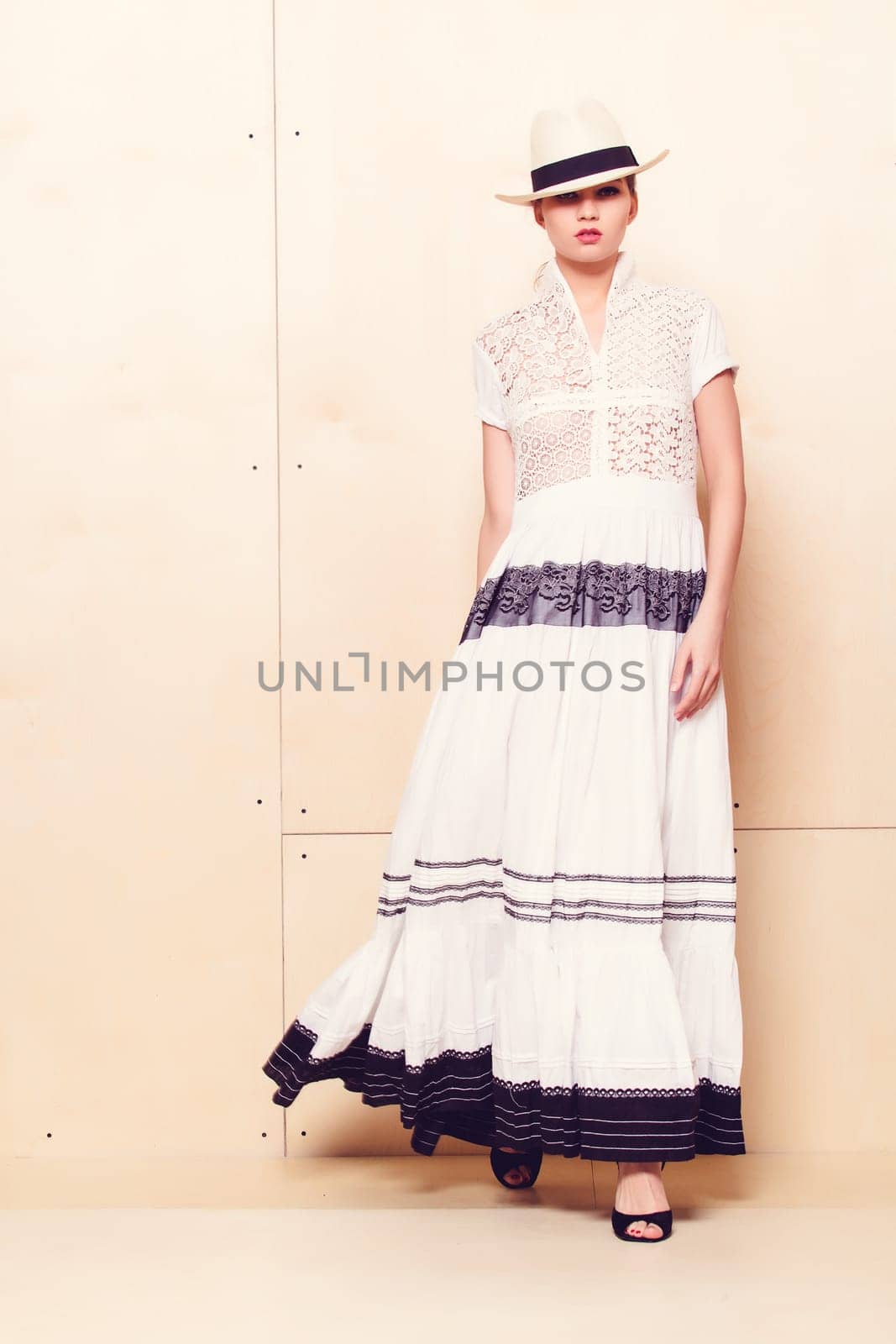 Full-length portrait of a lovely woman in romantic dress on wodden background