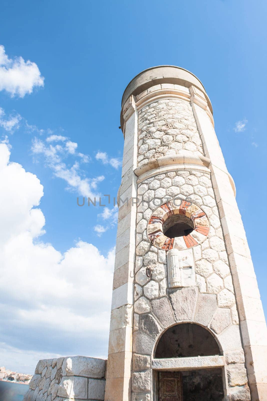Lighthouse Photovoltaic Sky . Sea Mark at the harbor with blue sky with clouds in background