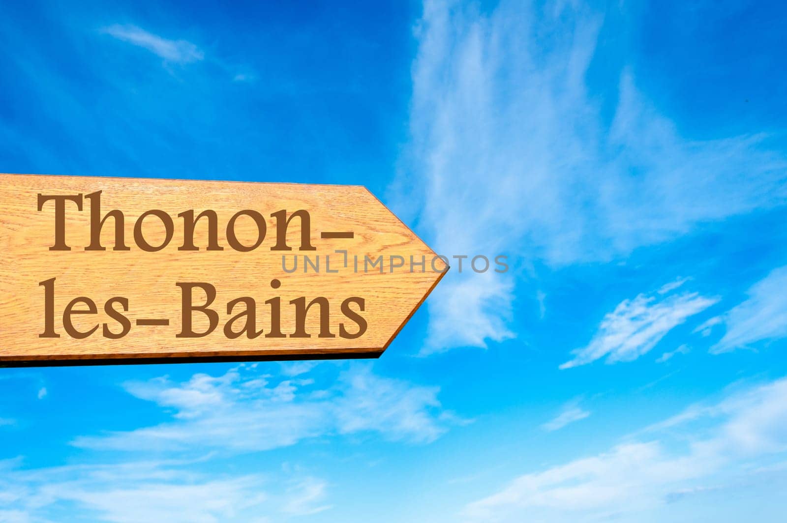 Wooden arrow sign pointing destination Versailles, FRANCE against clear blue sky with copy space available. Travel destination conceptual image