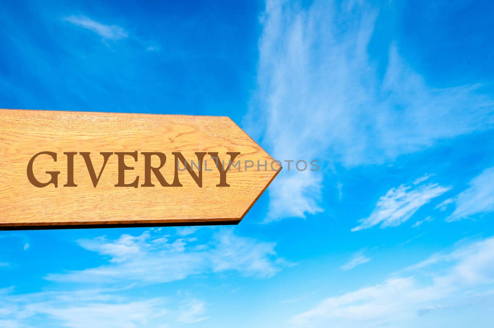 Wooden arrow sign pointing destination Versailles, FRANCE against clear blue sky with copy space available. Travel destination conceptual image