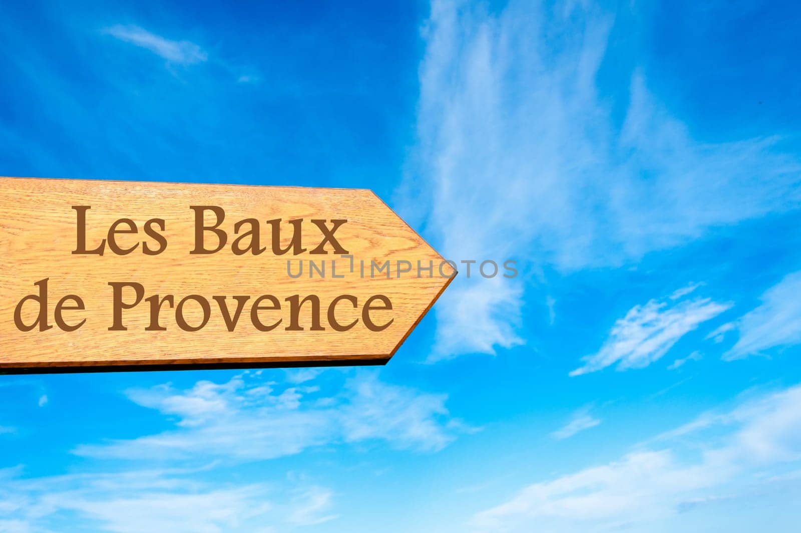 Wooden arrow sign pointing destination Versailles, FRANCE against clear blue sky with copy space available. Travel destination conceptual image