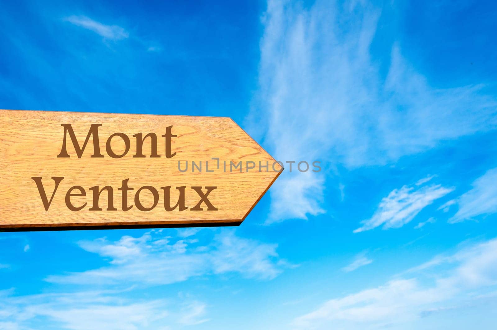 Wooden arrow sign pointing destination Versailles, FRANCE against clear blue sky with copy space available. Travel destination conceptual image