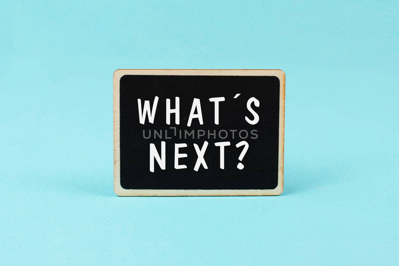 The phrase what´s next is standing on a chalkboard, having new goals and strategies, making plans for future