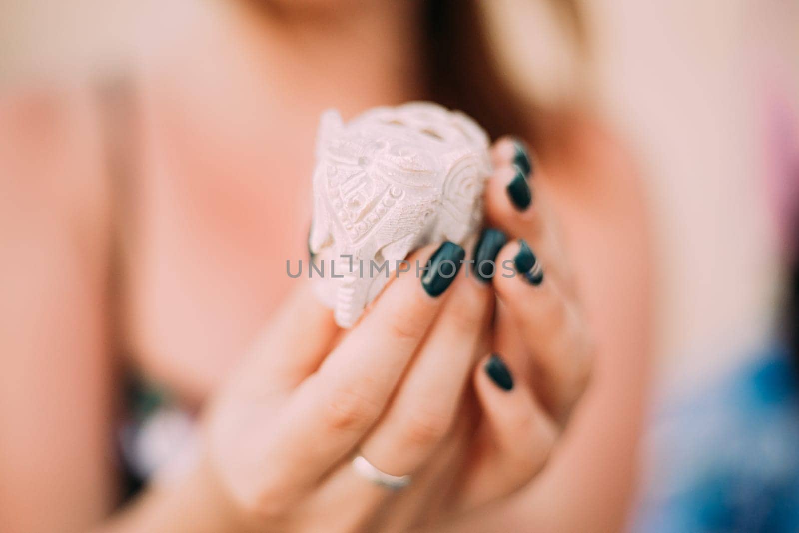 Goa, India. Elephants Souvenirs Of Stone In Woman's Hand.
