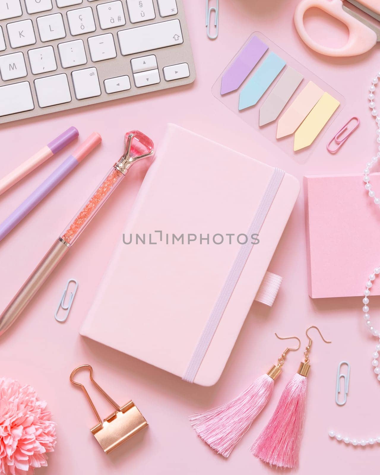 Hardcover notebook, Pink school accessories and keyboard on light pink, Top view, textbook mockup. Girly workplace with notebook, scissors, pencil, pen, paperclips, cards and watch. Back to school