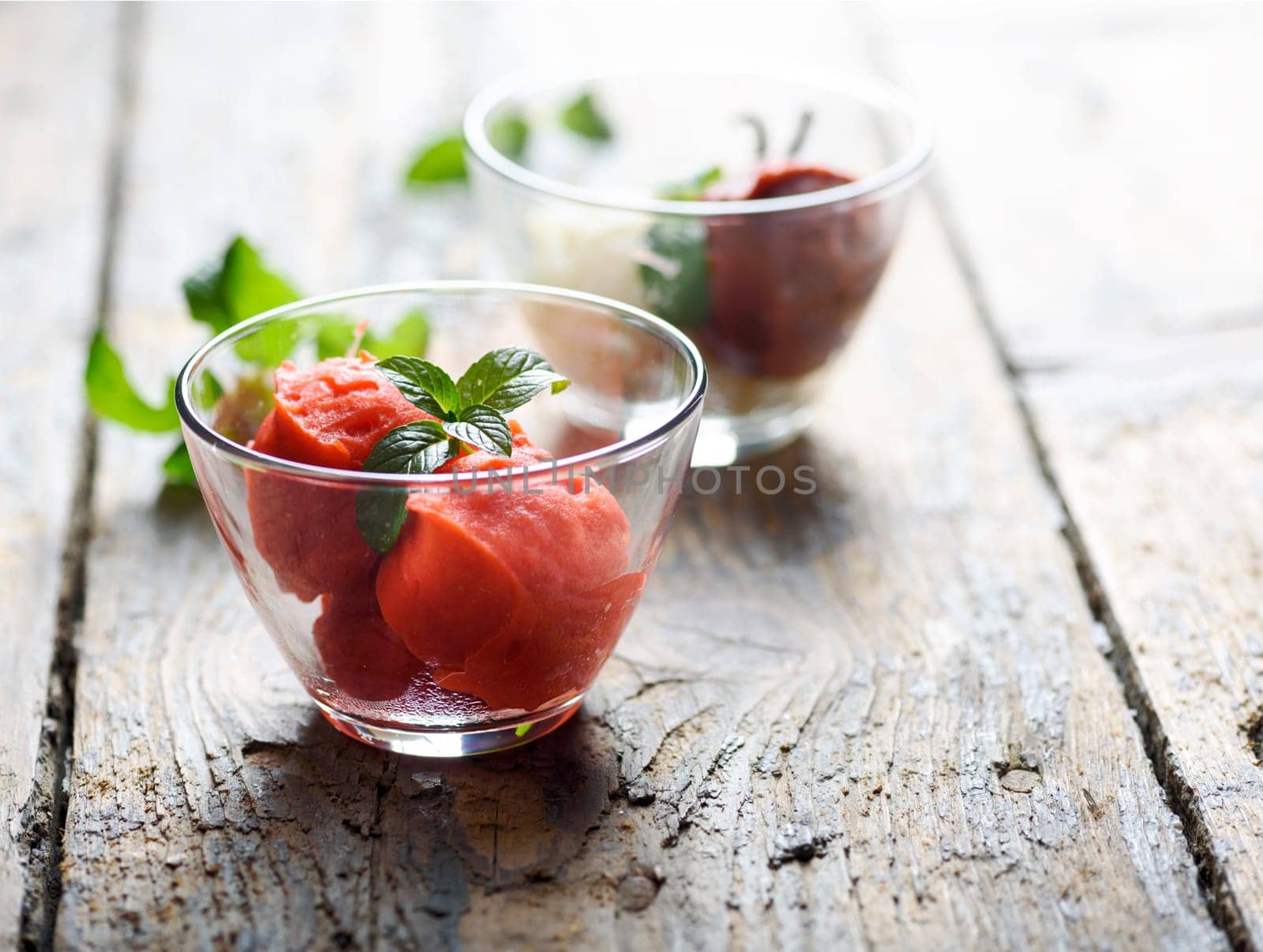 Ice cream dessert of strawberry, chocolate and vanilla on vintage wooden background.