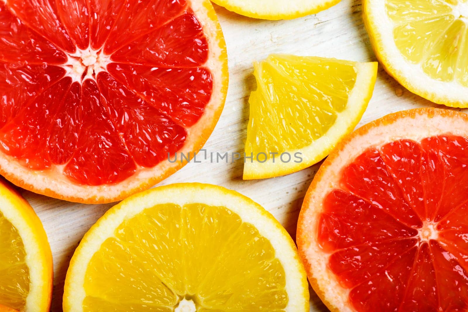 Citrus slices pattern background on whte wooden table.