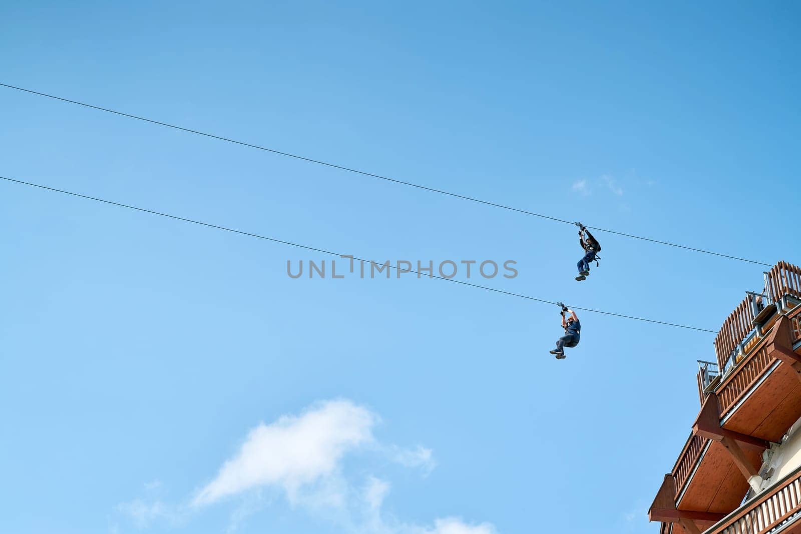 Two adventurous brave men on a zipline in Magdeburg in Germany