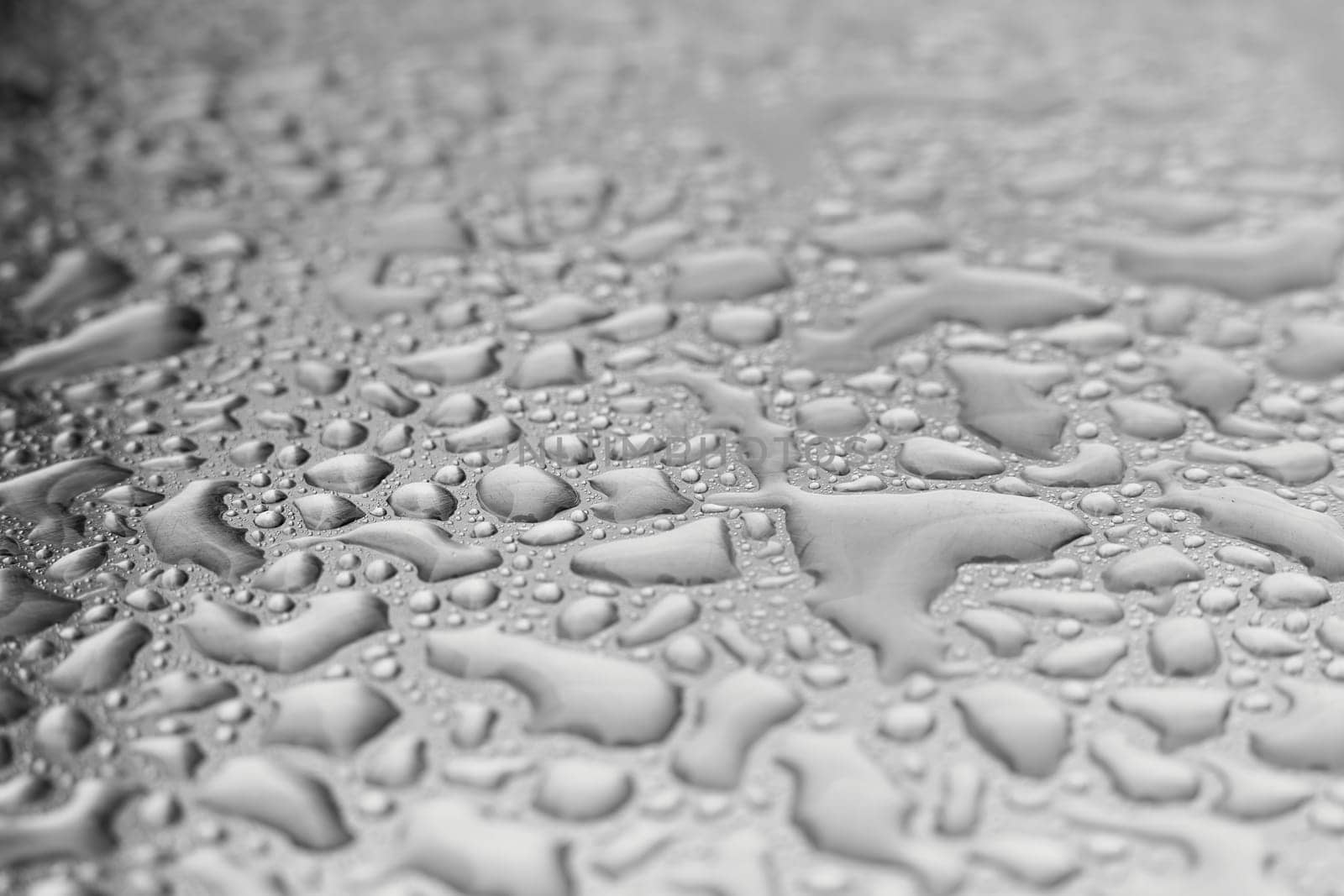 Water on a stainless steel metal plate after a heavy rain
