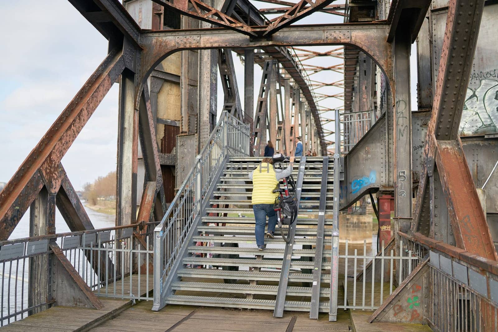 Pedestrians crossing the dilapidated lift bridge over the river Elbe near Magdeburg