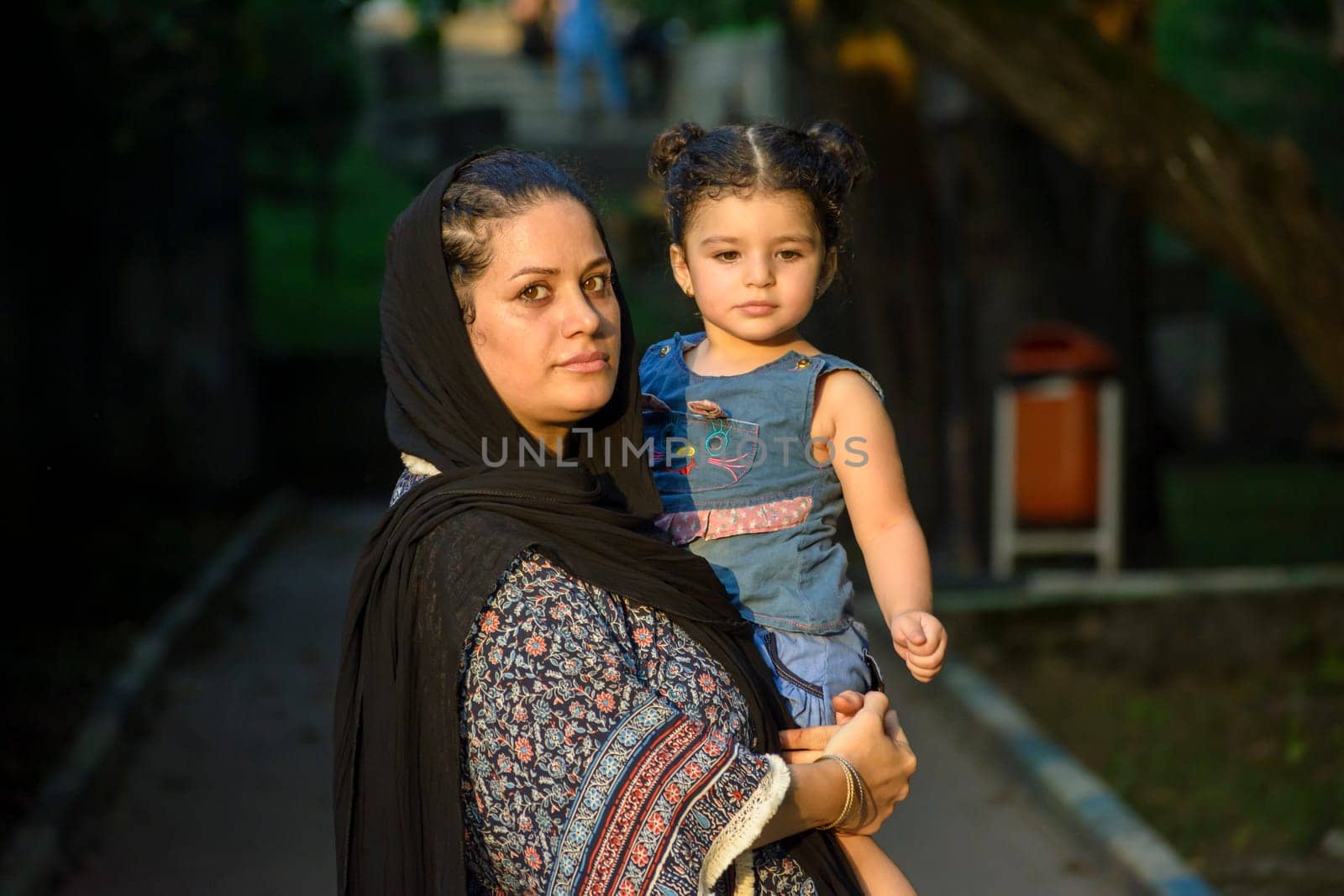 Young mother with her two years girl  in her hug , Muslim family at outdoor area