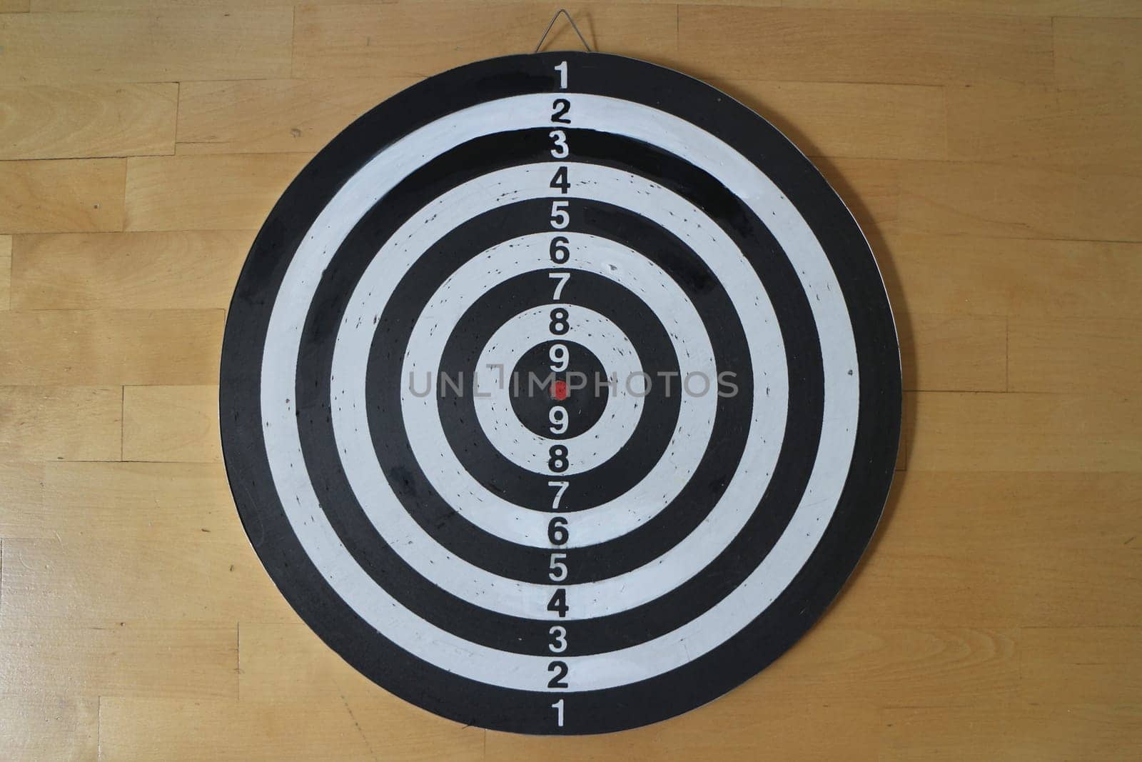 striped black and white Dartboard with numbering wooden background