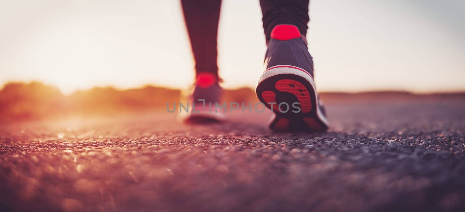 Woman starting to run outdoors in the evening. Concept of healthy lifestyle.