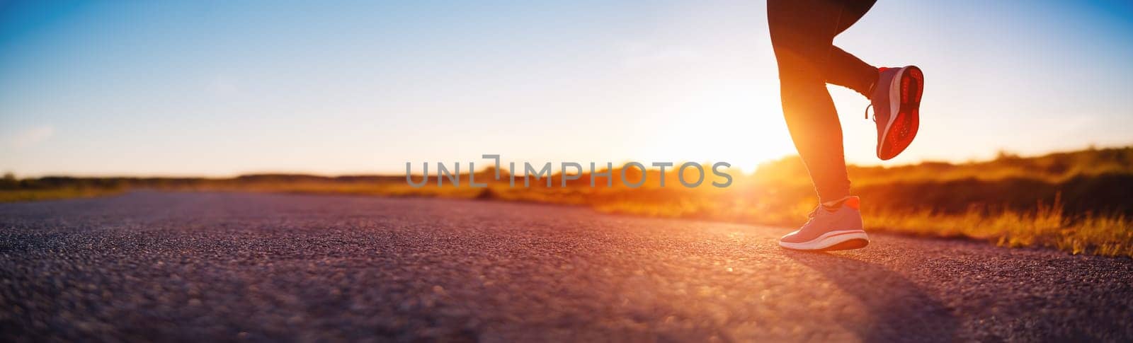 Woman running outdoors on the evening sunset. Concept of healthy lifestyle.
