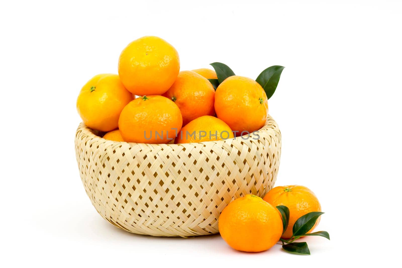 fresh tangerines in a basket on white background