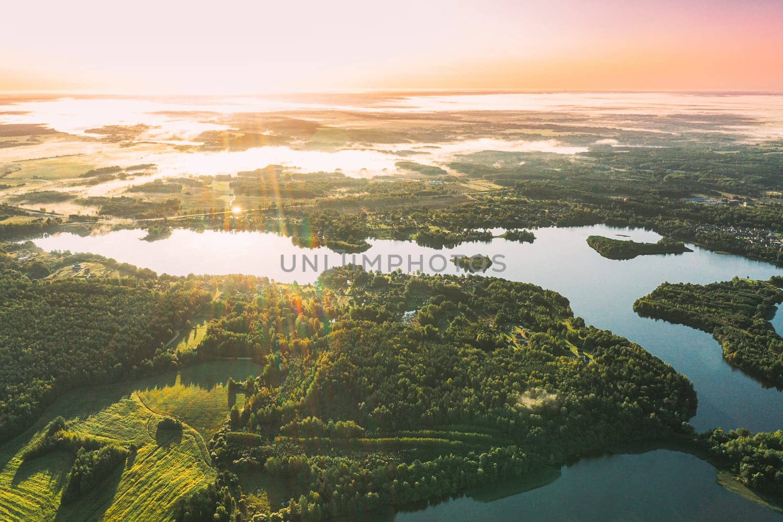 Lyepyel District, Vitebsk Region, Belarus. Aerial View Of Sunset Sunrise Above Residential Area With Houses In Countryside. Morning Fog Above Lepel Lake. Bird's Eye View Of Lepel Lake.