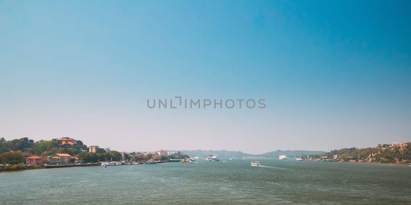 Panaji, Goa, India. Water Navigation On The Mandovi River. Ships Floating On River.
