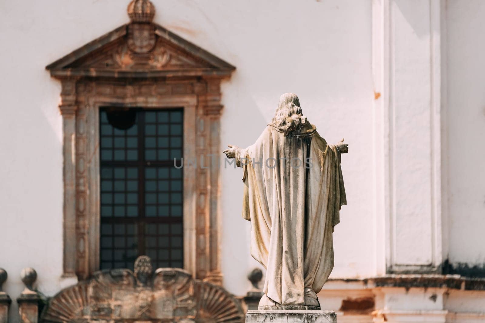 Old Goa, India. Cathedral Of St. Paul And Statue Of Jesus In Sunny Day.