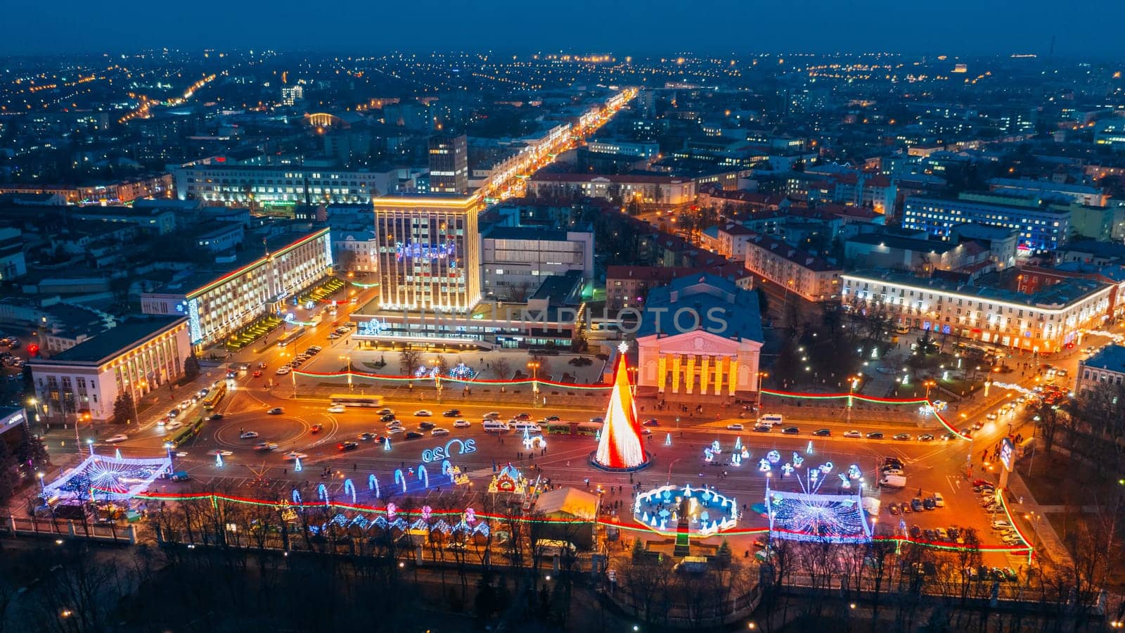 Gomel, Belarus. Main Christmas Tree And Festive Illumination On Lenin Square In Homel. New Year Celebration In Belarus. Aerial Night View.