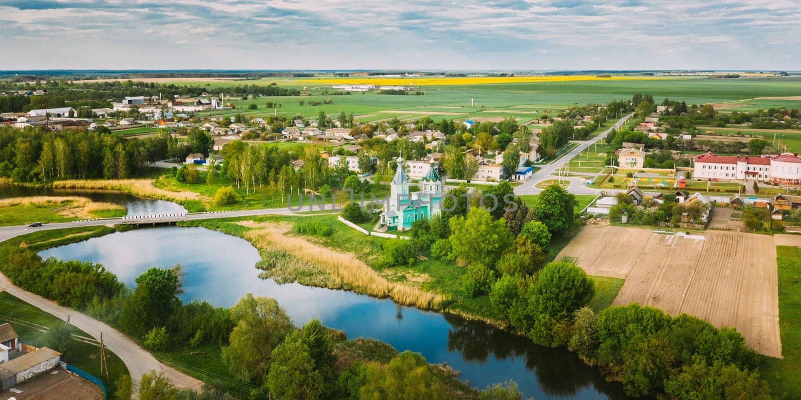 Krupets, Dobrush District, Gomel Region, Belarus. Aerial View Of Old Wooden Orthodox Church Of The Holy Trinity At Sunny Summer Day.