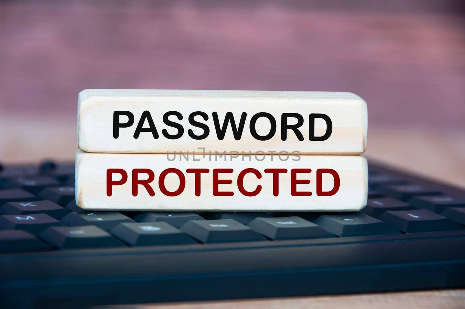 Password protected text on wooden block on top of keyboard. Password security concept