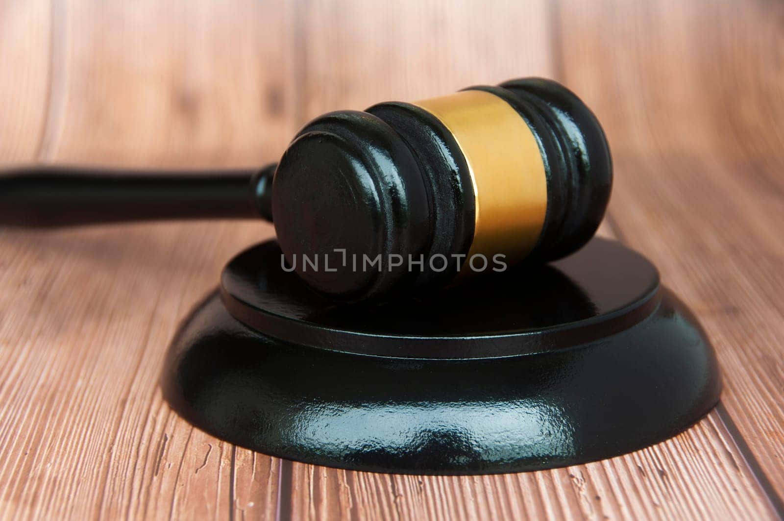 Close up of judge gavel on wooden desk background. Law concept
