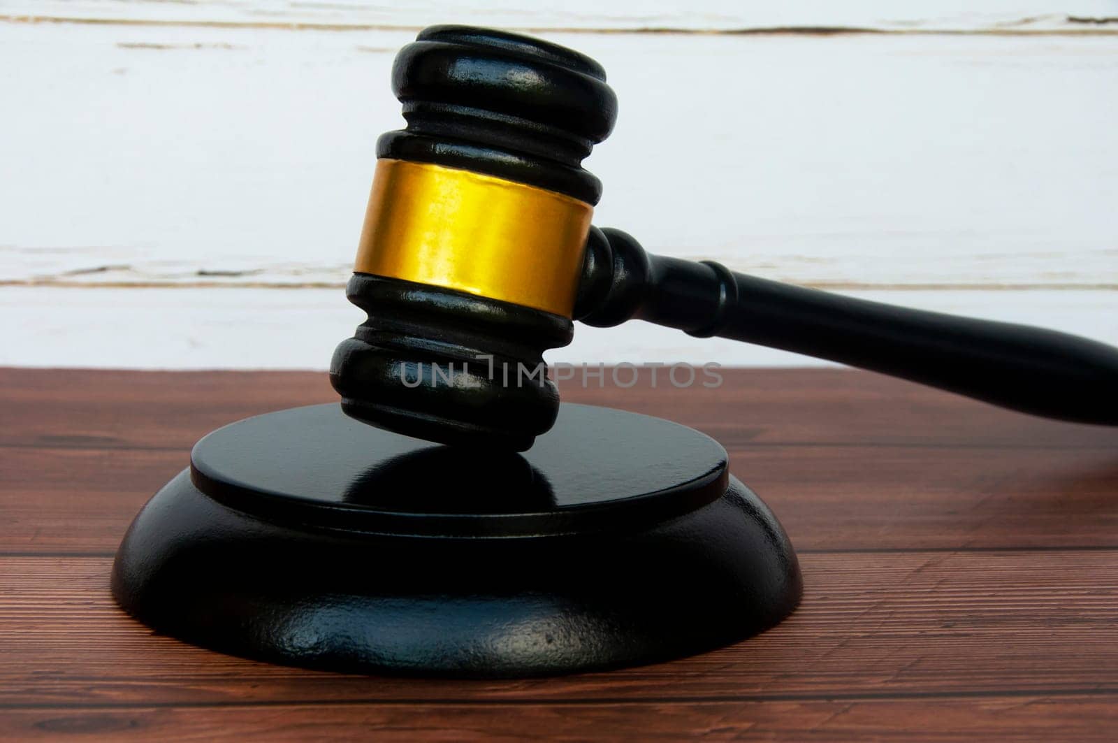 Side view of gavel on wooden table background. Justice and law concept.