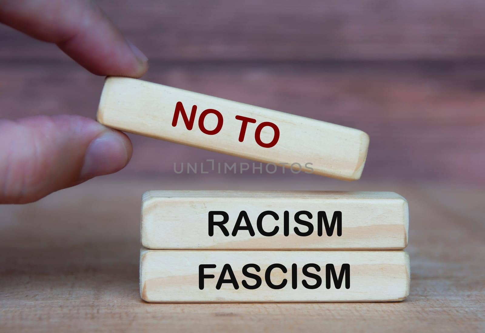 Hand holding no to racism and fascism. Rights protection culture concept.