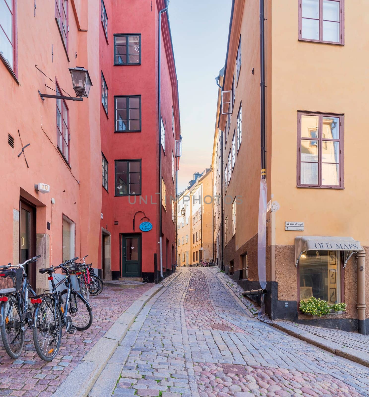 Narrow alley located in Gamla stan, the old town of Stockholm, Sweden with old style colorful houses, parked bicycles, and cobblestone street, Stockholm, Sweden