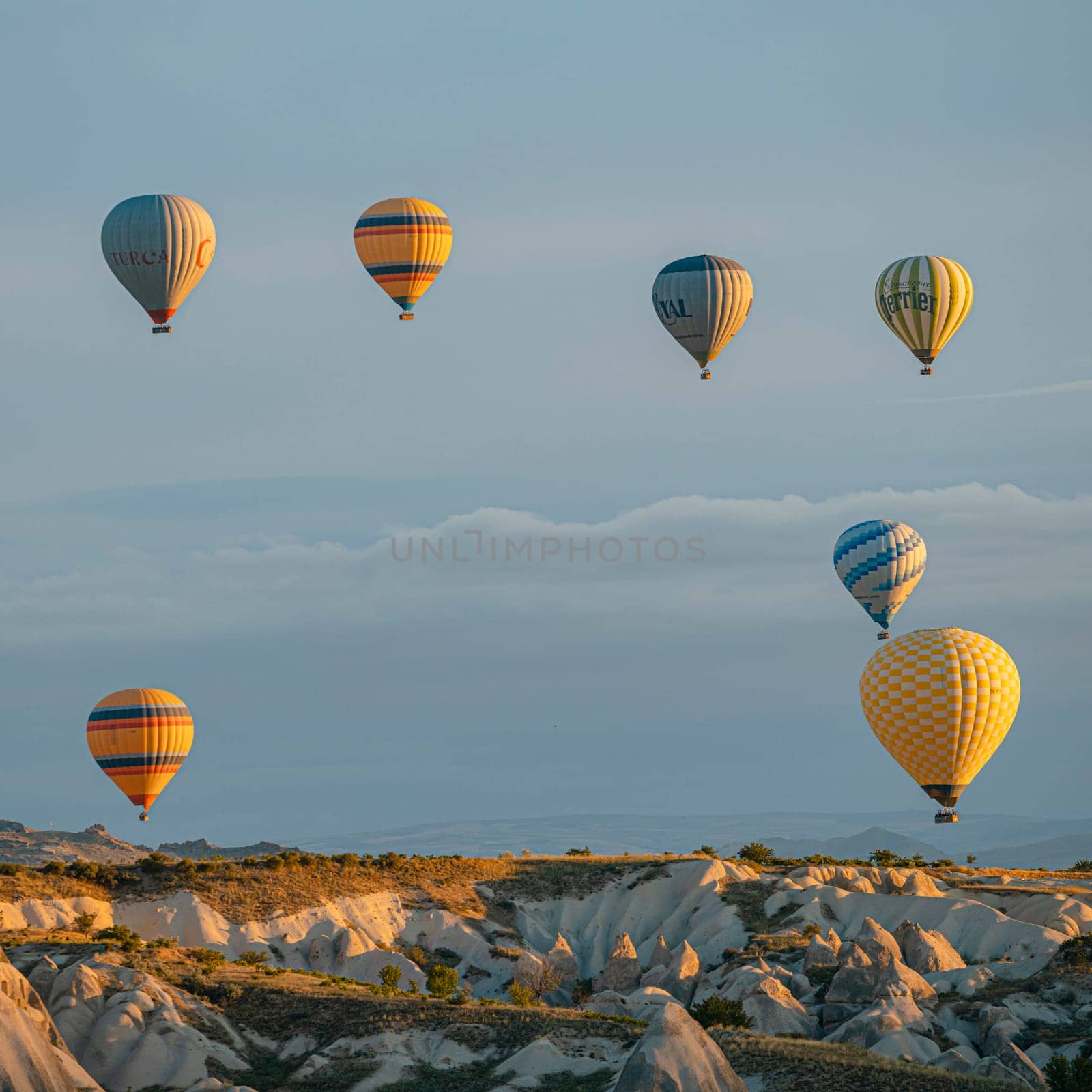 GOREME/TURKEY - June 27, 2022: hot air balloons flying over the hills