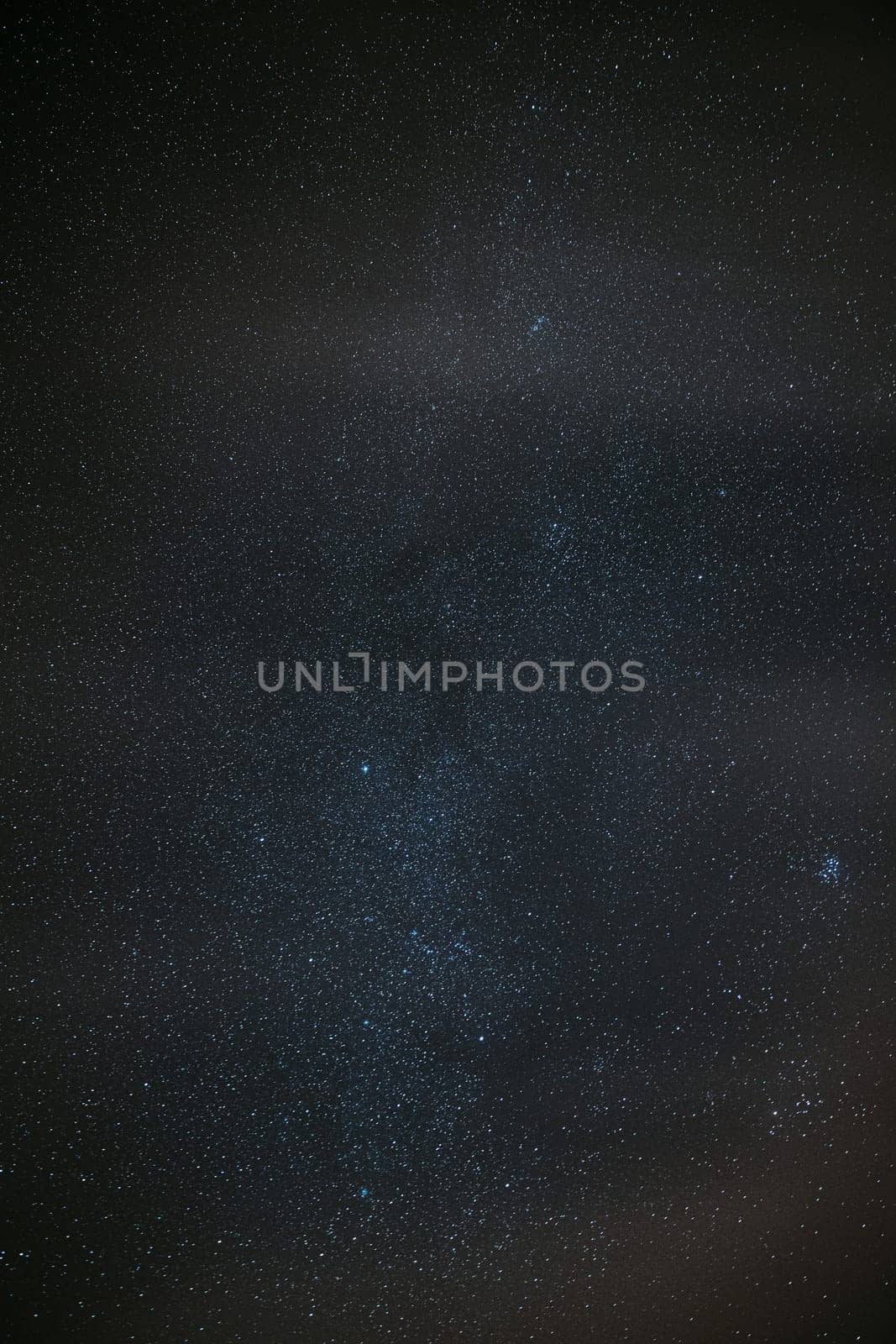 Milky Way Galaxy Glowing Through The Light Cloudiness Overcast. Real Night Sky Stars. Natural Starry Sky Dark Black Background Backdrop.