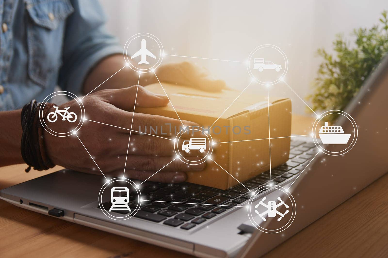 Hand of Casual Businessman or Entrepreneur Catch Parcel or Box on Laptop and Logistic or Transportation Icon. SME Online Business and E-commerce Concept for Work at Home