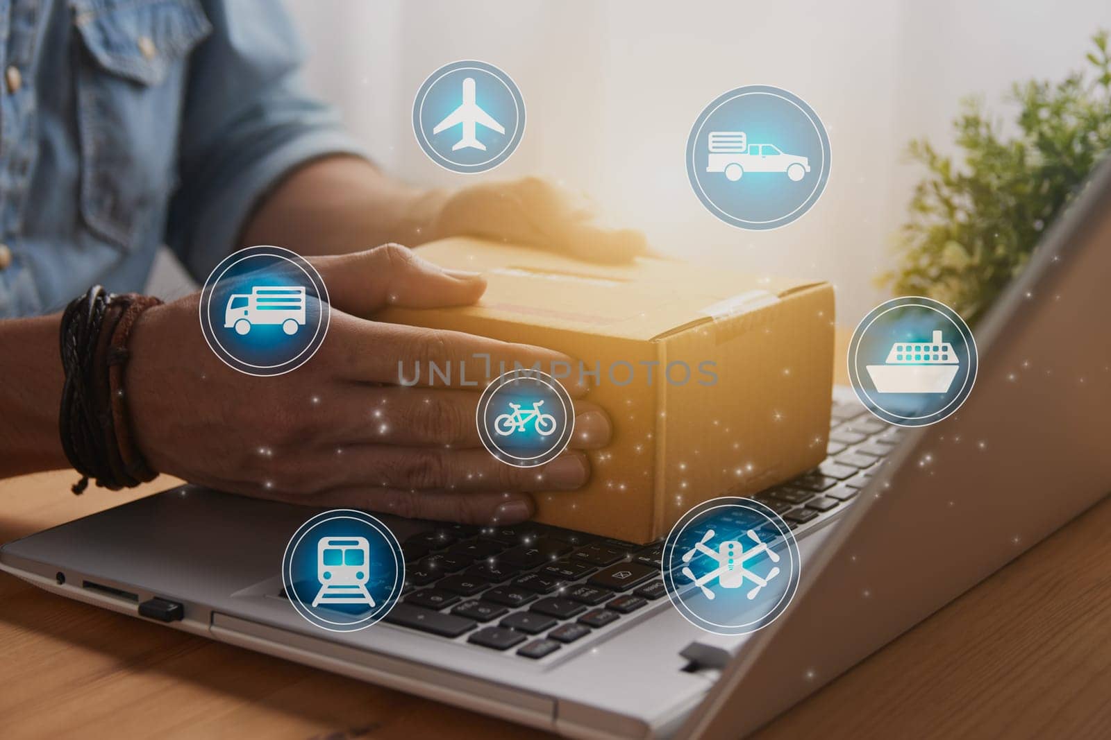 Hand of Casual Businessman or Entrepreneur Catch Parcel or Box on Laptop and Blue Logistic or Transportation Sign. SME Online Business and E-commerce Concept for Work at Home